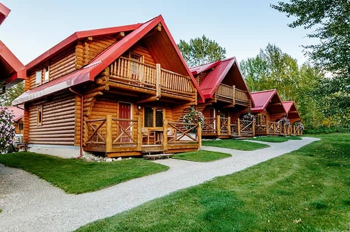 A wooden cabin with a red roof