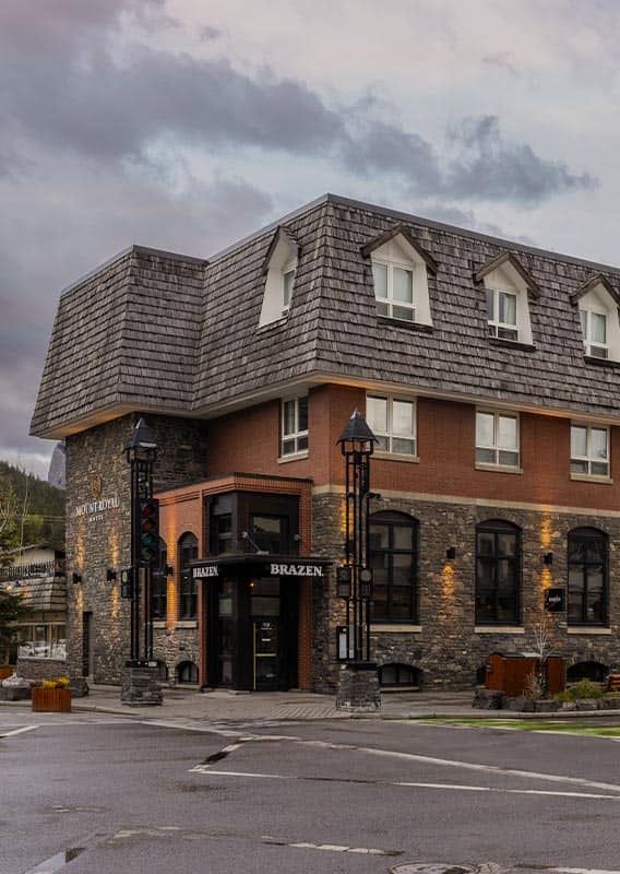 The exterior of a hotel at a street corner.