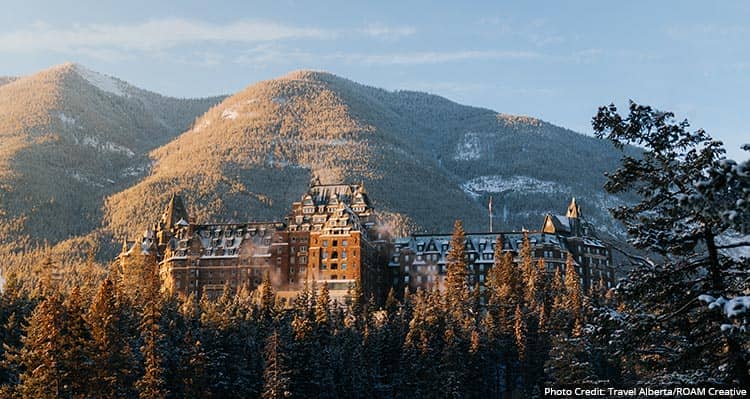 A large hotel in a forested mountain landscape.