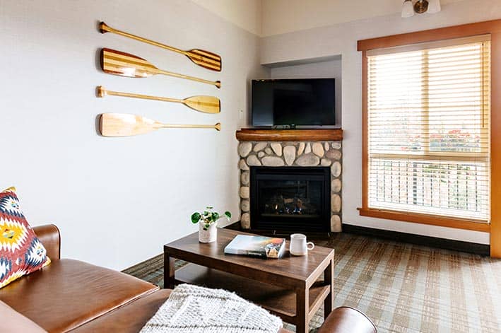 A bright living area with fireplace and coffee table.