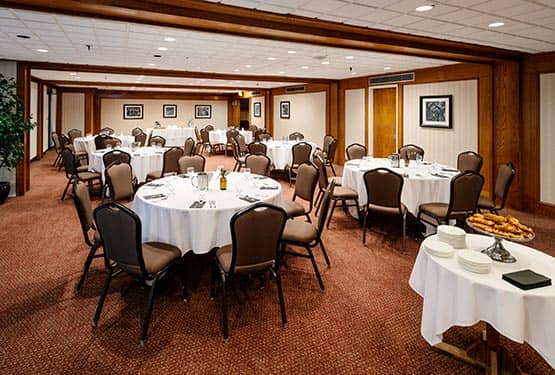 A large meeting room set up with round tables