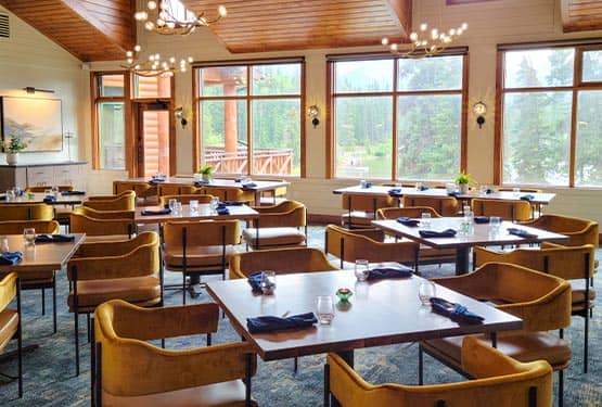 A restaurant private dining room with tables and bright windows