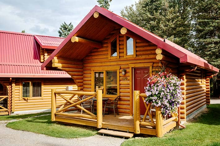 A small cabin with red roof nestled among trees