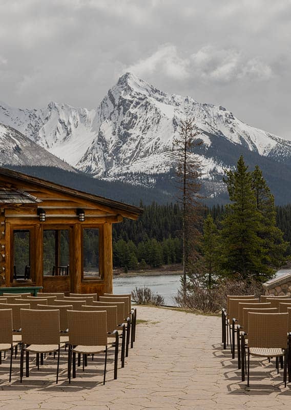 Rows of chairs set up for a wedding in a mountain landscape.