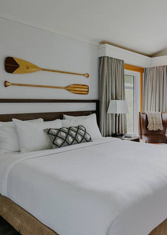 Hotel room with wooden paddles on the wall.