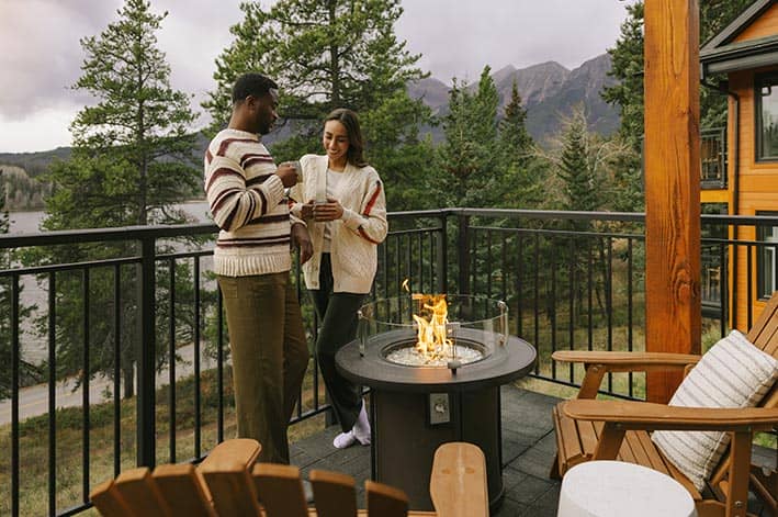 Two people standing on an outside balcony.