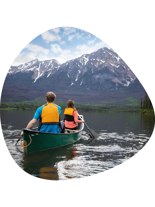 Two canoeists on a calm lake.